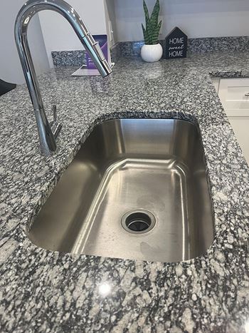 Deep stainless steel kitchen sink with garbage disposal
